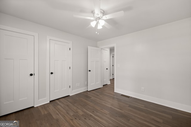 unfurnished bedroom featuring dark wood-type flooring and ceiling fan