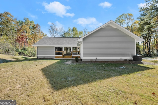 rear view of house with a yard and central air condition unit