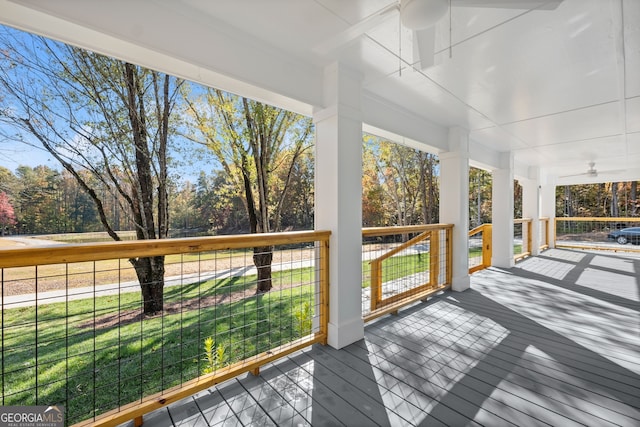 wooden terrace with a lawn