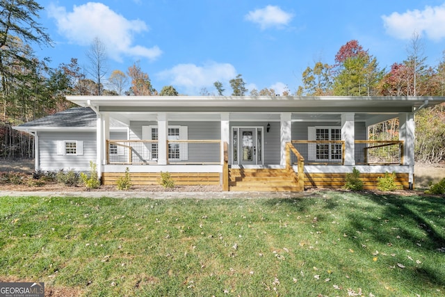 ranch-style house featuring covered porch and a front yard