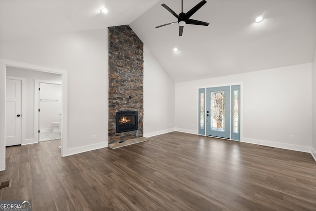 unfurnished living room featuring dark hardwood / wood-style floors, high vaulted ceiling, a fireplace, and ceiling fan