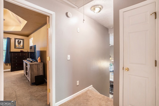 hallway featuring light colored carpet