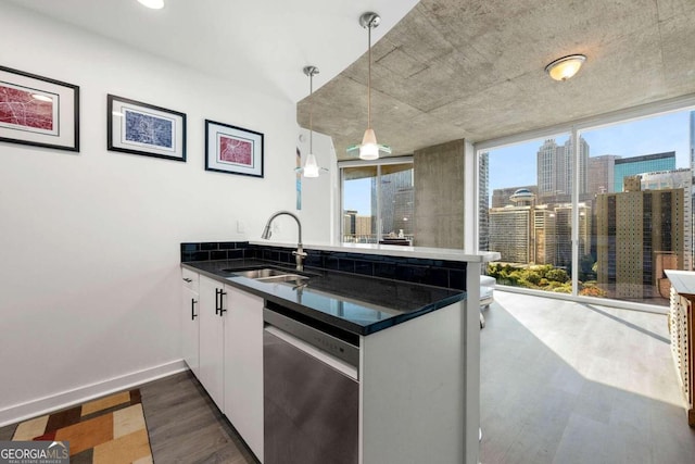 kitchen with white cabinets, sink, dishwasher, dark hardwood / wood-style floors, and hanging light fixtures