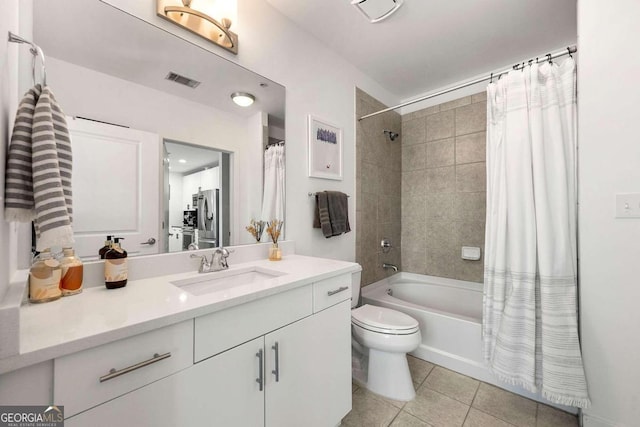 full bathroom with tile patterned flooring, vanity, shower / tub combo, and toilet