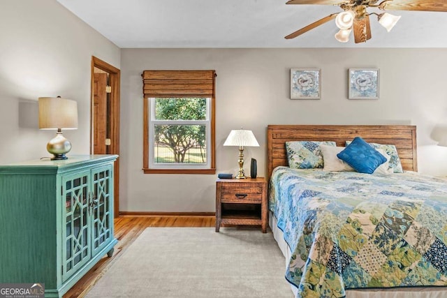 bedroom featuring hardwood / wood-style floors and ceiling fan