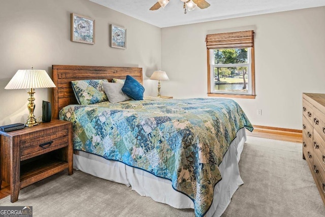 bedroom featuring light colored carpet and ceiling fan