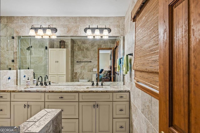 bathroom with vanity, a shower, tile walls, and backsplash