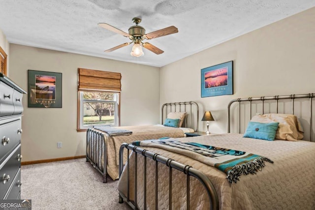 bedroom with light carpet, a textured ceiling, and ceiling fan