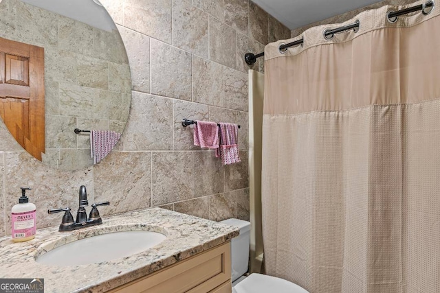 full bathroom featuring vanity, toilet, shower / bath combination with curtain, and tile walls