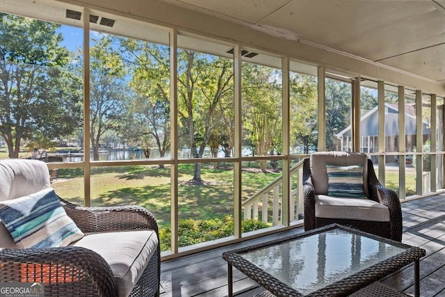 sunroom / solarium with a wealth of natural light and a water view