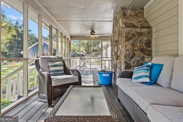 sunroom / solarium featuring ceiling fan