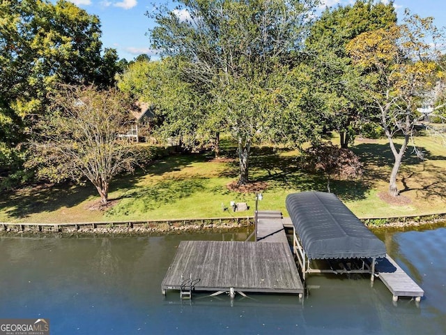 view of dock with a water view and a lawn