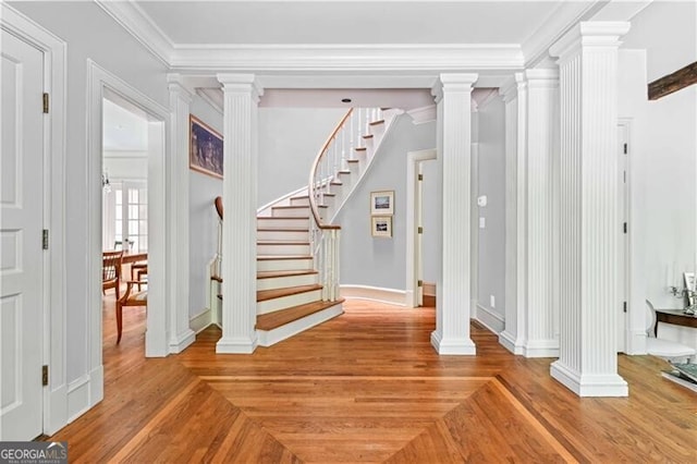 entryway featuring wood-type flooring and ornamental molding