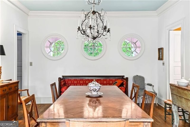 dining area with hardwood / wood-style flooring, a wealth of natural light, and ornamental molding