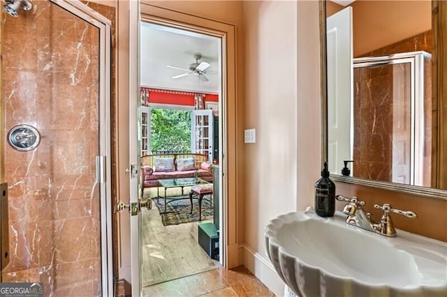 bathroom with tile patterned flooring, ceiling fan, a shower with shower door, and sink