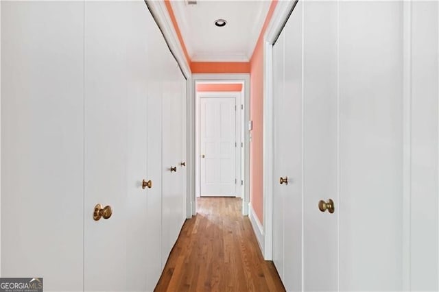 corridor featuring hardwood / wood-style floors and ornamental molding