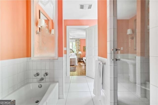 bathroom with tile patterned flooring and independent shower and bath