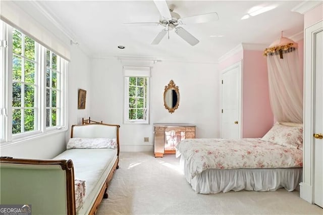 bedroom featuring multiple windows, light carpet, ceiling fan, and ornamental molding