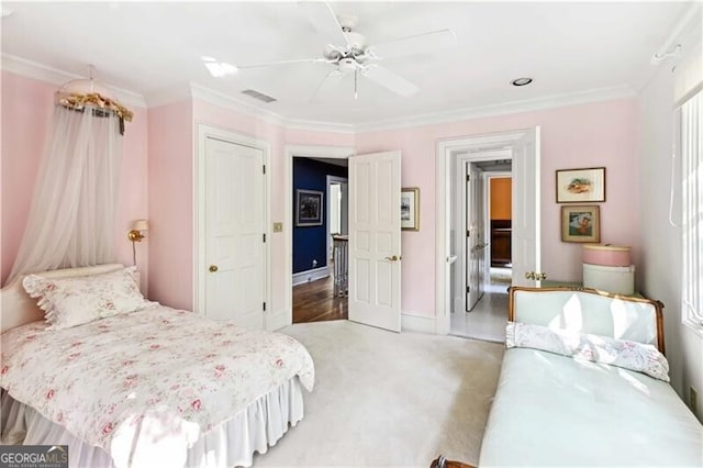 bedroom featuring ceiling fan, carpet, and ornamental molding