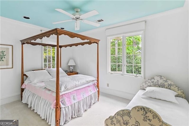 bedroom featuring ceiling fan, crown molding, and light carpet