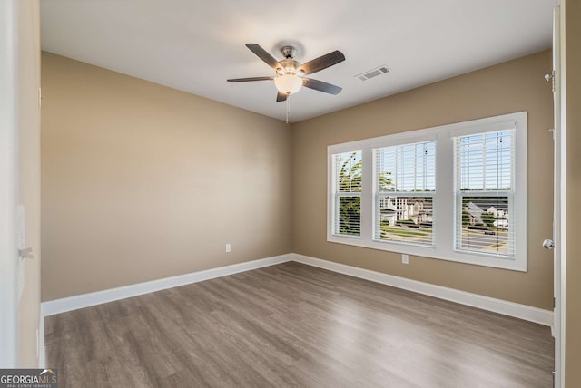 empty room featuring ceiling fan and hardwood / wood-style floors