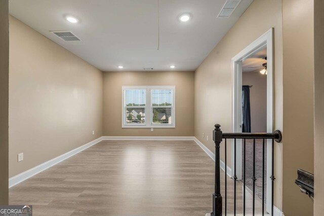 empty room featuring ceiling fan and light hardwood / wood-style flooring