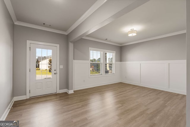 foyer featuring crown molding and light wood-type flooring