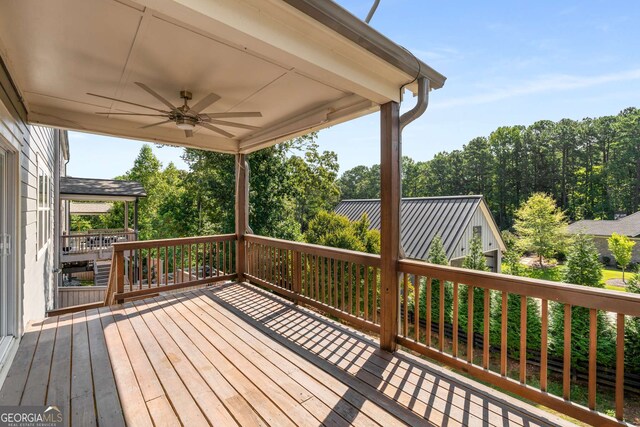 wooden deck featuring ceiling fan