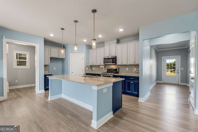 kitchen with appliances with stainless steel finishes, sink, light hardwood / wood-style floors, white cabinets, and blue cabinetry