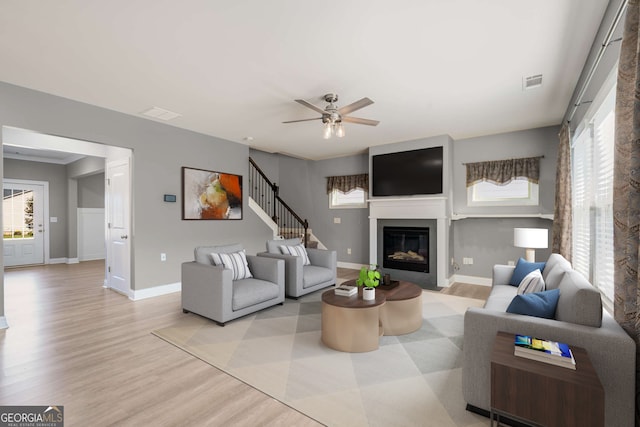 living room with ceiling fan and light wood-type flooring