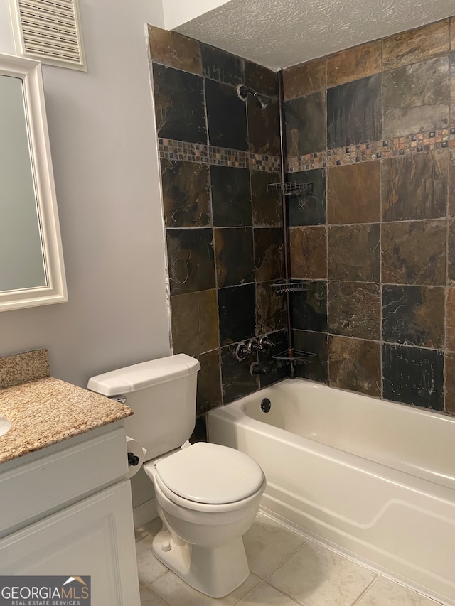 full bathroom featuring a textured ceiling, toilet, vanity, tiled shower / bath combo, and tile patterned flooring