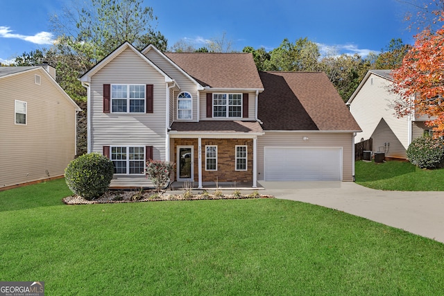 view of front facade with covered porch, a front yard, and a garage