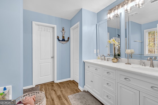 bathroom with vanity and hardwood / wood-style flooring