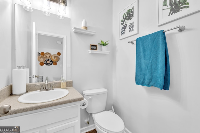 bathroom featuring vanity and toilet