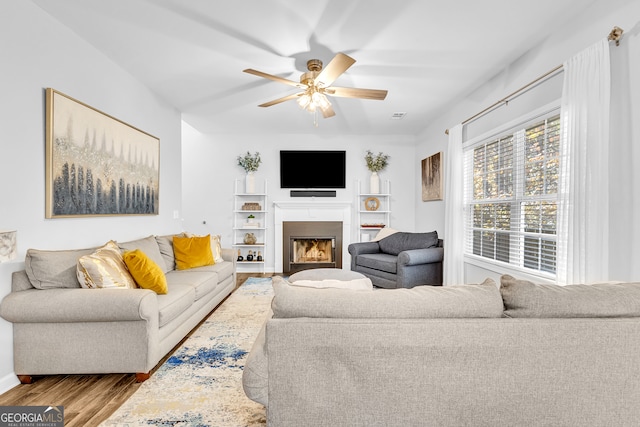 living room with ceiling fan and light wood-type flooring