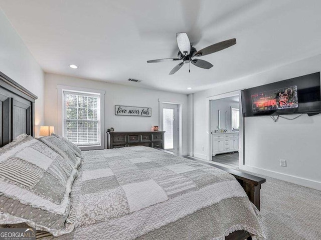 carpeted bedroom featuring ceiling fan and ensuite bathroom