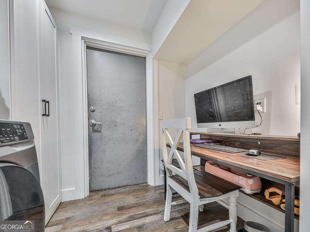 office space with washer / clothes dryer and light wood-type flooring