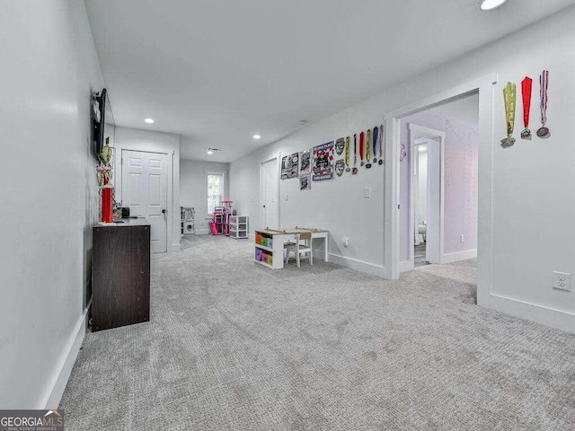 recreation room featuring light colored carpet