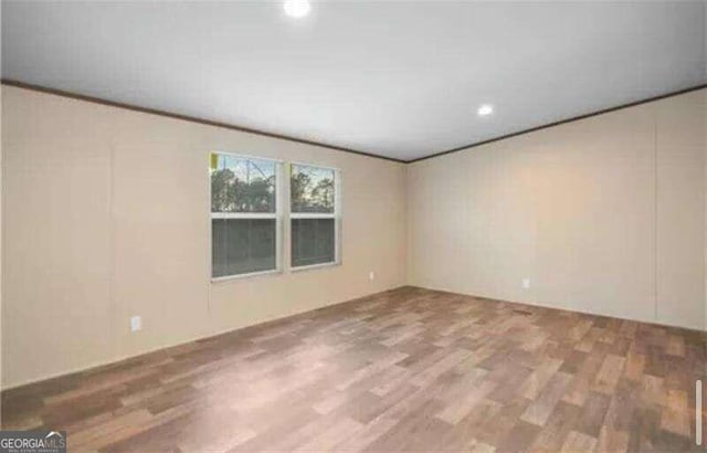 unfurnished room with hardwood / wood-style floors