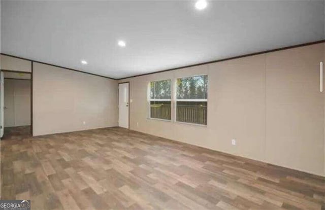 empty room with hardwood / wood-style flooring