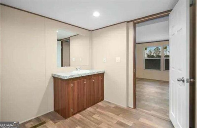 bathroom with vanity and hardwood / wood-style floors