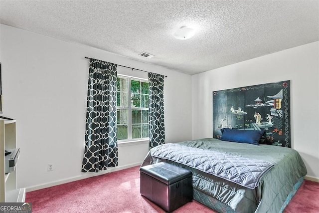 bedroom with a textured ceiling and carpet flooring