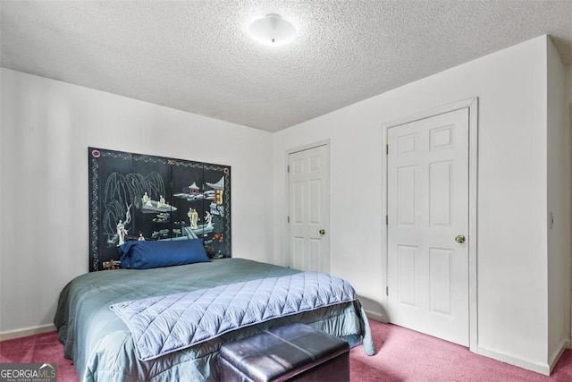 bedroom with carpet floors and a textured ceiling