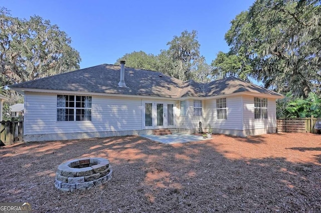 back of property featuring a patio and a fire pit