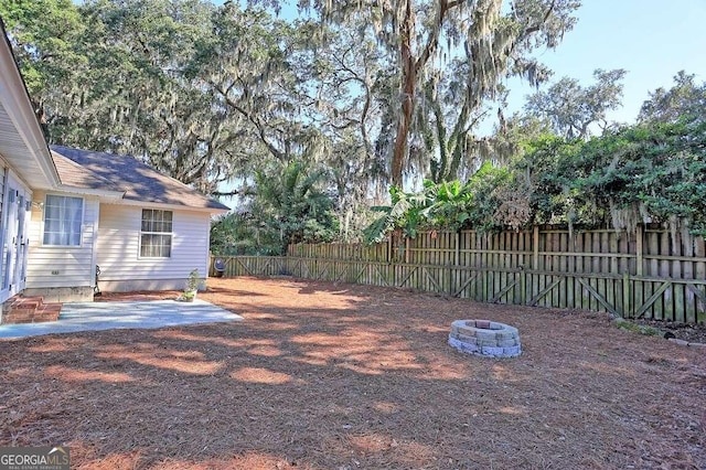 view of yard with an outdoor fire pit