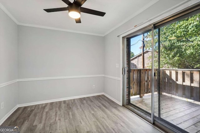 spare room with ornamental molding, hardwood / wood-style floors, and ceiling fan