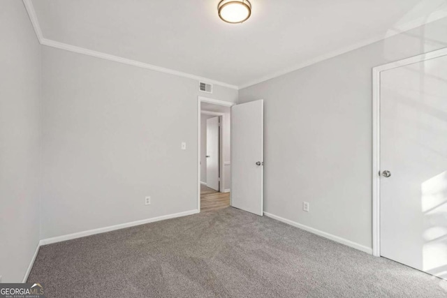 unfurnished bedroom with crown molding and carpet flooring