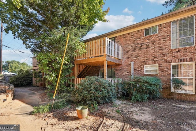 rear view of property with a wooden deck