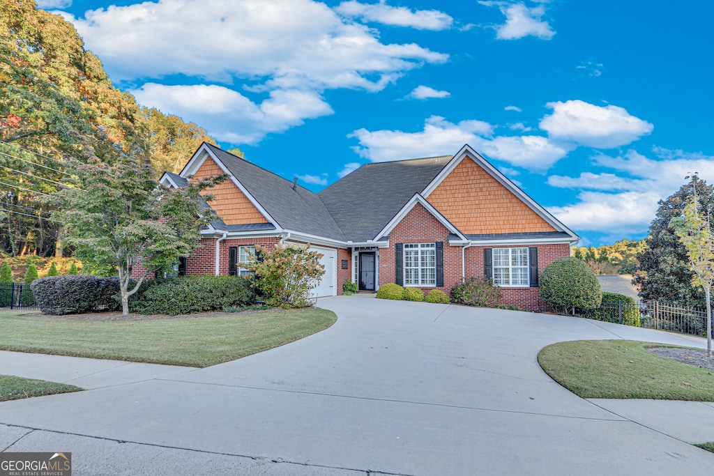 view of front facade with a front lawn and a garage