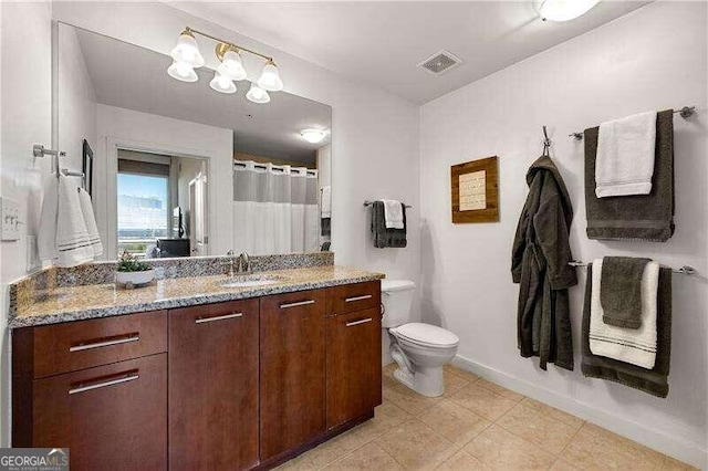 bathroom featuring vanity, toilet, and a shower with shower curtain